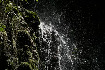 Fotobehang Agua salpicando al caer en las rocas con musgo © Antonio