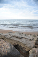 The horizon of the sea against the background of a rocky coast in summer