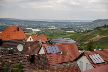 European cityscape with red clay roofs solar panels and rural view
