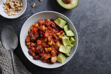 Chili con carne with avocado served on plate