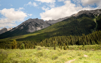 Fototapeta premium Great Rocky Mountains under magnificent clouds and sunlight, at Banff National Park, Calgary, Canada
