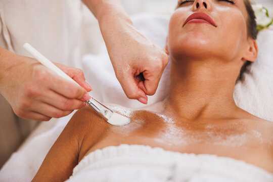 Woman Getting A Facial Mask Treatment At The Beauty Salon