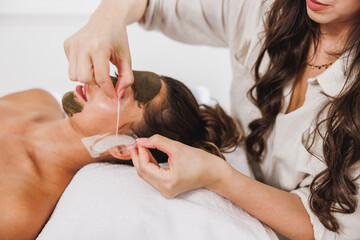 Obraz na płótnie Canvas Woman Getting A Facial Mask Treatment At The Beauty Salon