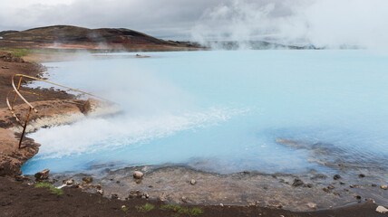 Namafjall, geothermal area in Hverir Hverarönd with tourists strolling. Boiling mud pools and hot springs. Tourist and natural attractions in Iceland Iceland, Europe