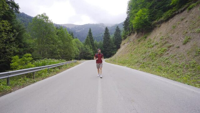 Freeman.
Lonely man in the forest. He's walking in the middle of the road.
