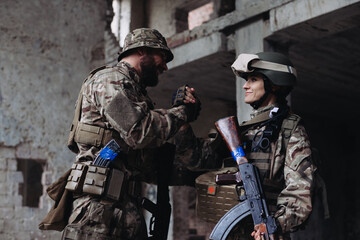 A female soldier gives a high five to her brother in arms.