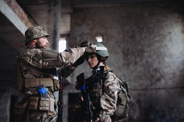 Fully equipped and armed ukrainian soldiers checking their equipment while taking a break..