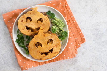Halloween tortilla pumpkin Mexican quesadilla filled with meat, onion, cheese