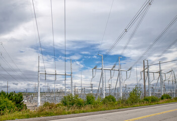 View inside of an electrical utility transformer station showing high voltage lines, pylons,...