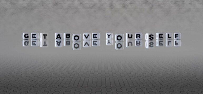 get above yourself word or concept represented by black and white letter cubes on a grey horizon background stretching to infinity
