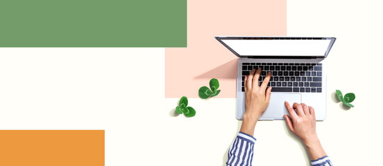 Laptop computer with shamrock leaves - flat lay