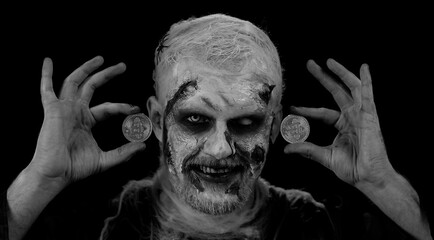Creepy man with bloody scars face, Halloween zombie showing golden bitcoins. Achievement career wealth, cryptocurrency investment, mining, future technology. Scary wounded undead guy smiles terribly