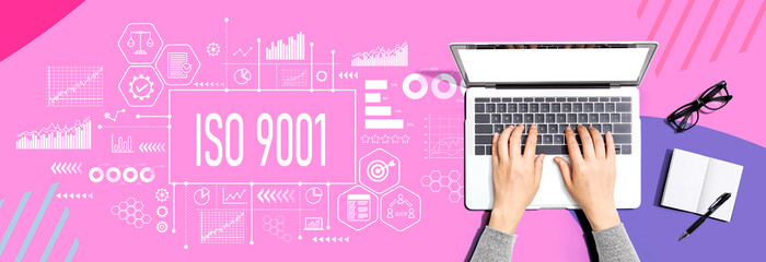 ISO 9001 theme with person using a laptop computer