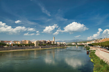 Landscape of the riverbed and bridge of the Ebro river from inside, city of Tortosa, Tarragona, Spain. In autumn season. 