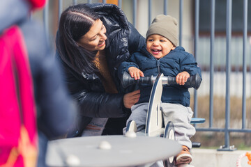 lovely shot of a cute little boy with his mom, outdoors. High quality photo