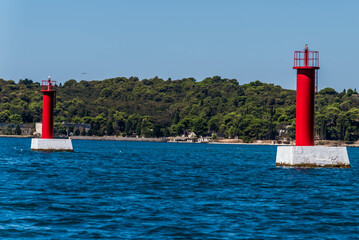red lighthouses in the sea near pula, croatia