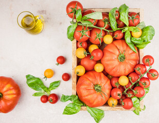 tomatoes and basil,  fresh vegetables in a wooden box 
