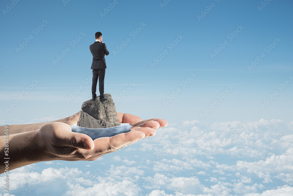 Aufkleber abstract image of hands holding thoughtful businessman standing on rock and water on bright blue sky
