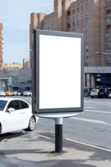 Vertical billboard for advertising and text. Light brick building in the background. Mock-up.