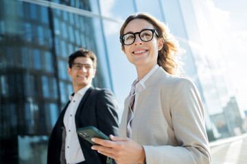 Entrepreneurs, a business woman and a man, communicate about the work of a colleague, go to work in...