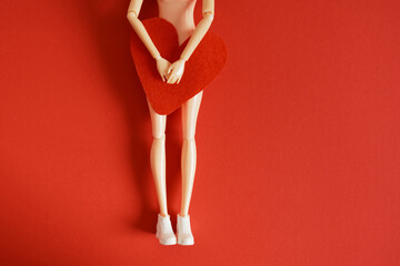 female doll and felt heart, woman health and love concept