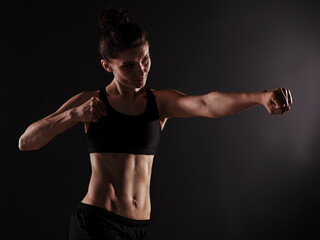 Attractive Sporty Young Caucasian Woman Doing Workout Exercise. Low Key Portrait Photo