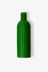 Green cosmetic bottle on a light background.