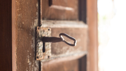 Old wooden weathered door, with antique brass key
