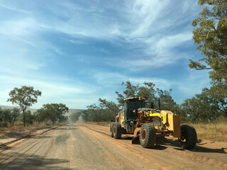 Earth moving grader working on a heavily corrugated road section of the Gibb river Western Australia