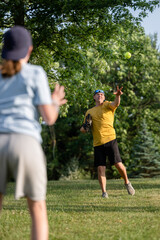 Marine veteran at home with family playing catch and teaching how to bunt a softball.