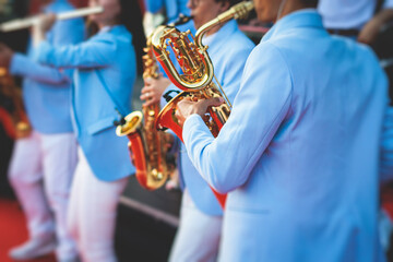 Concert view of saxophonist, a saxophone sax player with vocalist and musical band during jazz...