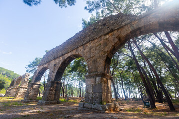 Fototapeta na wymiar Ruins of aquaeduct in ancient city Phaselis, Antalya Province, Turkey. Lycian ancient civilization heritage.