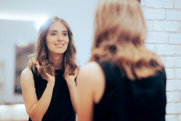 Woman Admiring Her New Look in the Mirror at a Hair Salon. Happy client loving her new colored...