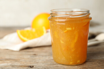 Homemade delicious orange jam on wooden table