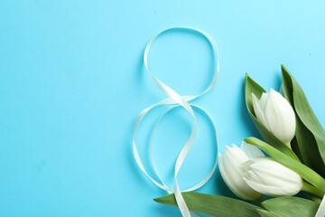 8 March card design with tulips and space for text on light blue background, flat lay. International Women's Day