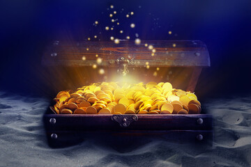 Open treasure chest with gold coins on sand seabed