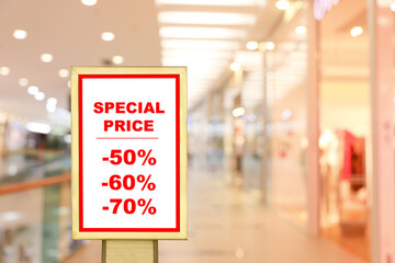 Advertising board with text Special Price and list of discounts in shopping mall