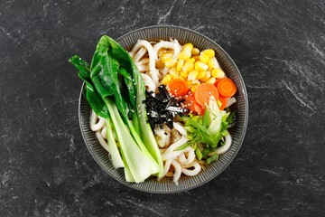 Healthy Japanese Dish, Vegetarian Udon Yaki. Udon Soup with Bok Choy, Carrot, Corn, and Green Onion in Garlic, Ginger and Soy Sauce.