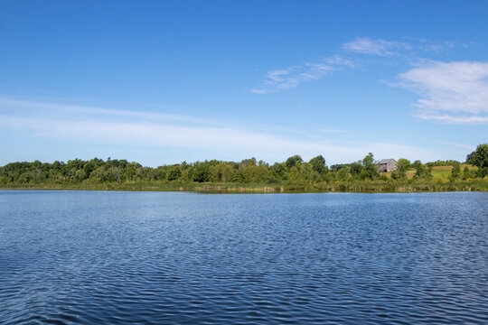 A Barn On Some Farmland On The Trent River In Ontario, Canada On A Summer Day