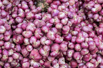 Red shallots on an old wood background.