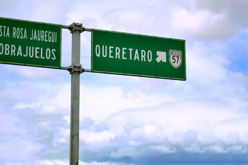Signboard in road. Signpost of direction in roadSignboard in road. Signpost of direction in road, of green color. Signpost in Querétaro, México. of green color. Signpost México.