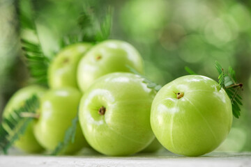 Indian Gooseberry or phyllanthus emblica fruits on nature background.