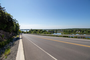 Man and dog walking down the road into Westport, Ontario from Foley Mountain Conservation Area