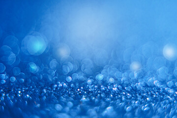 festive abstract glitter bokeh of blue background for Christmas