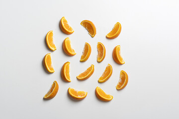 creative layout of orange fruit slices on white surface