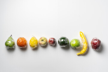 set of some fresh fruits in transparent plastic wrap