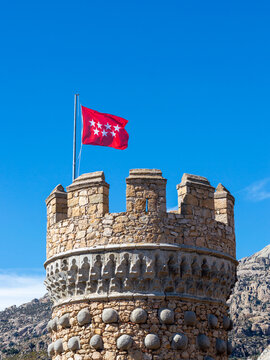 Community of Madrid Flag in a tower of the Castle Manzanares el Real in Madrid,Spain