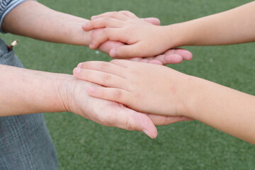 Grandmother holding her grandson's hand.