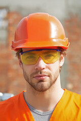 Portrait of worker man at construction site. Construction builder.