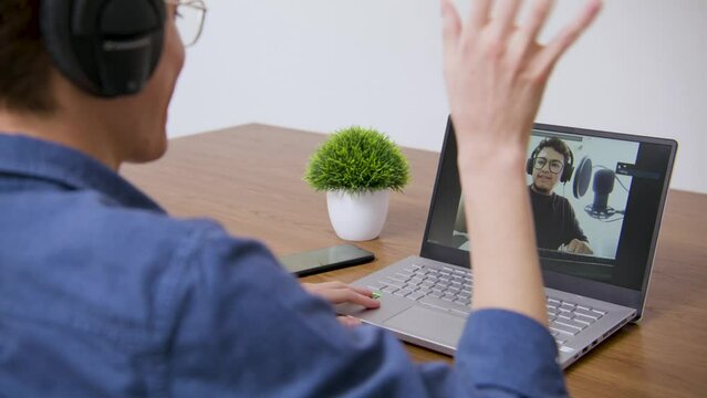 Guy joining a video call with a friend and greeting him